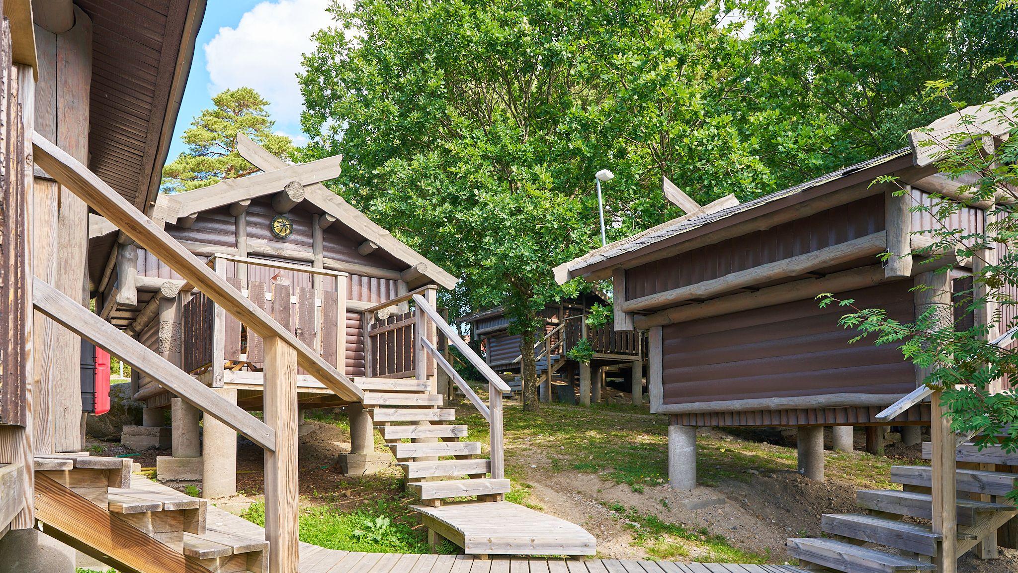 a group of wooden buildings with stairs leading up to them .